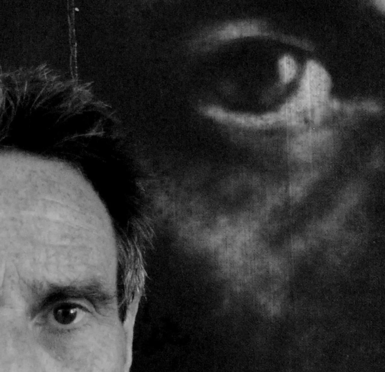 John Keane looking at the camera, you can only see the left side of John's face